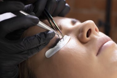 Kirpik uzatma prosedürü. Uzun kirpikli kadın gözü.