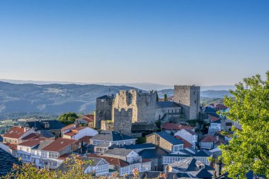 View of Castro Caldelas village and castle in Orense Spain at sunset clipart