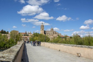 Salamanca, İspanya, Mayıs 2018: katedral kule Salamanca Roma Köprüsü aracılığıyla ve arka planda yürüyen turist