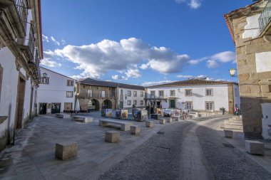 Miranda mı Douro, Portekiz, Nisan 2017: Miranda içinde bir onur Cape ve kadın ile geleneksel kış giysileri giyen adam bronz heykelleri ile tarihi Meydanı mı Douro Portekiz