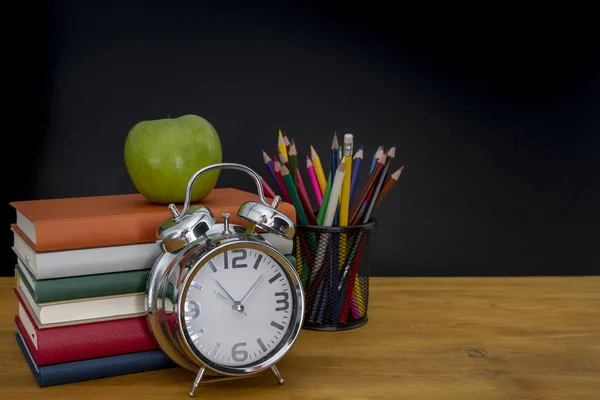 学校のコンセプトです 本と黒板の前に木製の机の上の鉛筆のスタック — ストック写真