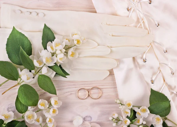 Wedding marriage concept.jasmine flowers frame on a wooden table top view.Wedding background with jasmine flowers and bridal accessoies.filtered toned photo flat lay.