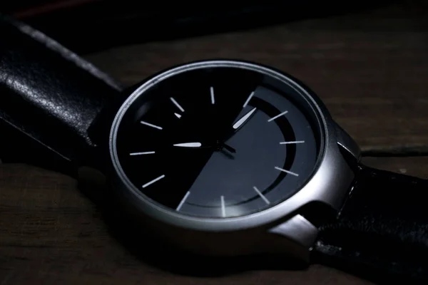 black wrist watch in low light image