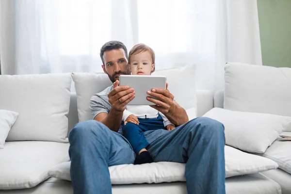 Handsome Caucasian Man Holding His Cute Baby Son Looking Tablet — Stock Photo, Image