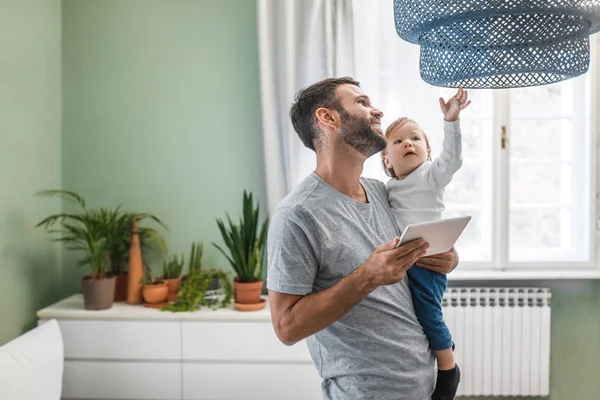 Happy Smiling Man Holding His Baby Son Home — Stock Photo, Image