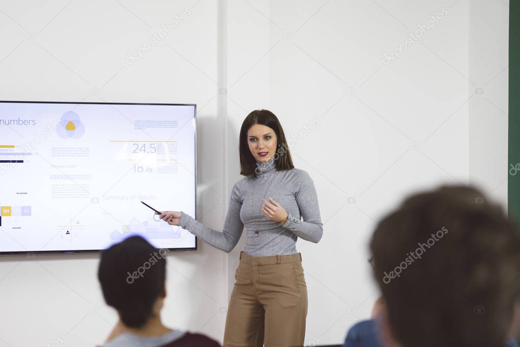 Young Woman Presenting In Front of Audience