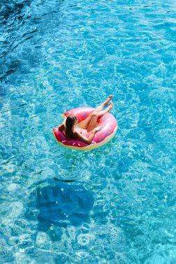 Güzel kadın Akdeniz ve zevk üzerinde kayan halka yatan güneşlenmek.