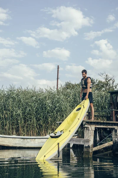 若いハンサムな白人男性カヤック川水の上を保持 — ストック写真