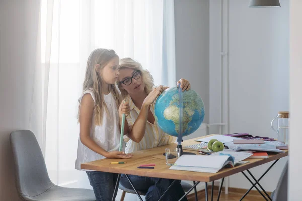 Pretty Caucasian Schoolgirl Learing Geography Globe Her Beautiful Mother Helping — Stock Photo, Image