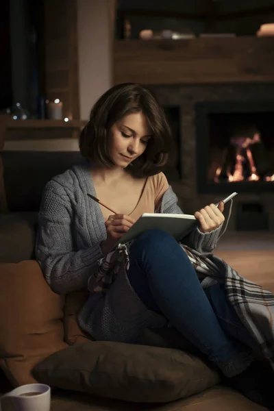 Beautiful Woman Sitting Fireplace Cozy Sweater Writing Notebook — Stock Photo, Image