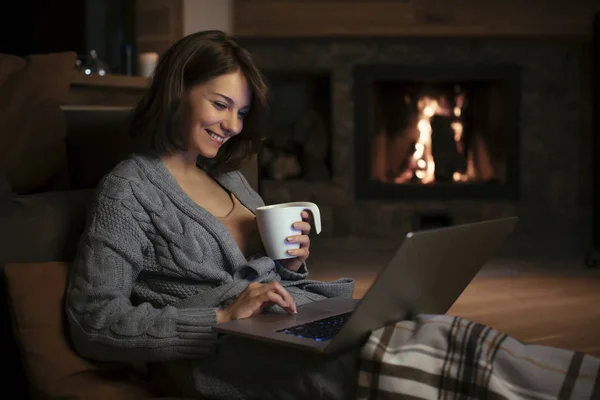 Mulher Muito Sorridente Bebendo Chá Lareira Olhando Para Laptop Noite — Fotografia de Stock