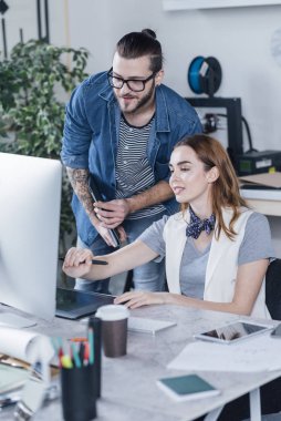 Birlikte ofiste çalışan genç modern erkek ve kadın grafik tasarımcı.