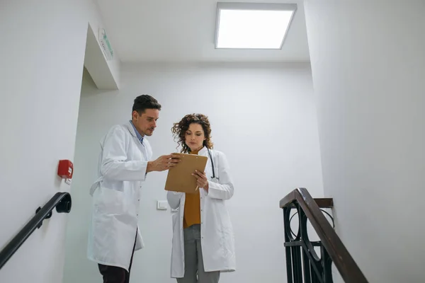 Deux Jeunes Médecins Caucasiens Parlent Dans Couloir Hôpital — Photo