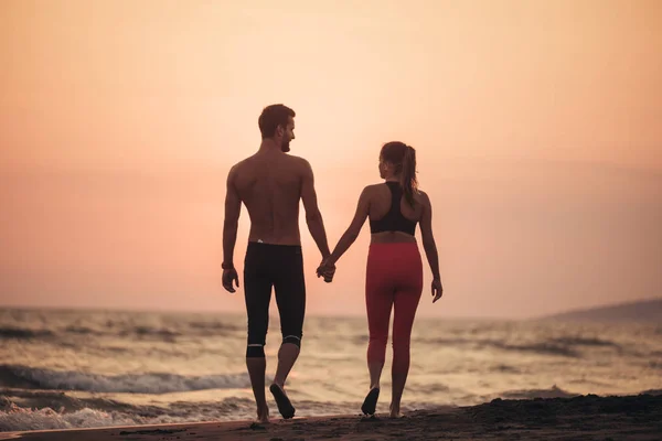 Молодой Человек Влюбленная Женщина Идут Рука Руку Песчаном Пляже Закате — стоковое фото