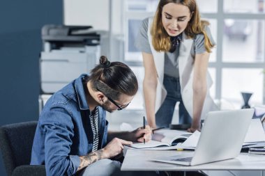 Birlikte çalışan genç erkek ve kadın tasarımcılar.