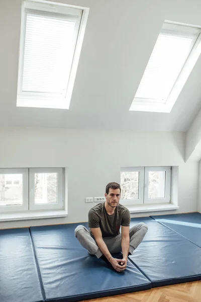 Young handsome Caucasian man stretching his groin. — Stock Image Young Handsome Caucasian Man Stretching His Groin Stock Picture