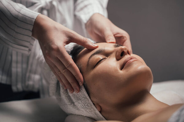 Woman Enjoying a Facial Massage