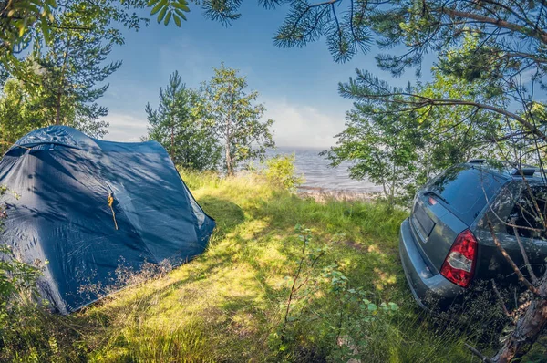 Camping in forest by the lake. Tent near the car. distortion perspective fisheye lens — Stock Photo, Image