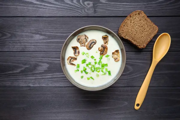 Cheese cream soup on dark wooden background. — Stock Photo, Image