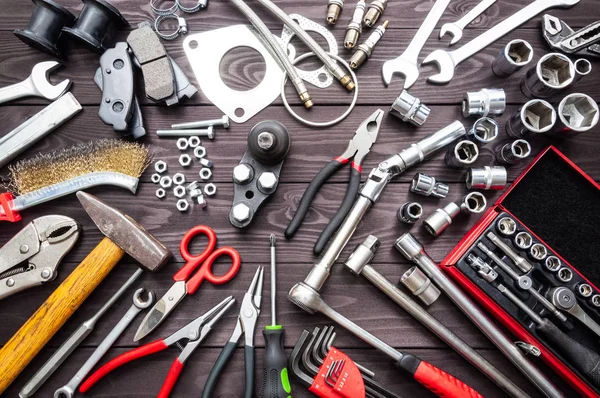 Tools and auto spare parts on wooden workbench — Stock Photo, Image