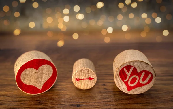 Love You sign illustrated on oval corks pieces