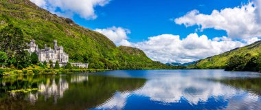 Kylemore Abbey, beautiful castle like abbey reflected in lake at the foot of a mountain. Ireland clipart