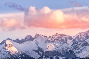 Sunset with dramatic sky and mountain peaks illuminated by sunlight in Tatra Mountains clipart