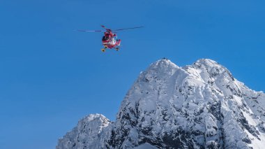Rescue helicopter saved mountain climbers in Tatra Mountains clipart
