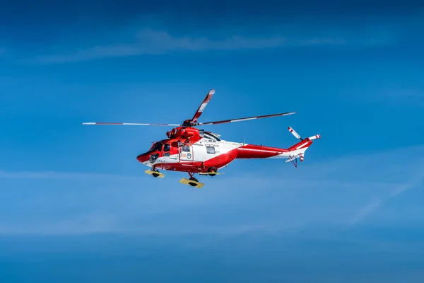 stock image Red and White helicopter, rescue team or crew flying over Kasprowy Wierch and Swinica in High Tatra Mountains, providing rescue service, Poland