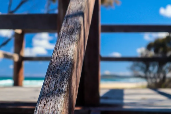 Close-up de um corrimão de madeira em um dia claro na praia — Fotografia de Stock