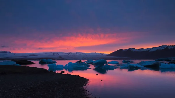 フォア グラウンドと氷河と山の黒い砂のビーチとバック グラウンド 南アイスランドで日没 Jkulsrln 氷河湖の流氷 — ストック写真