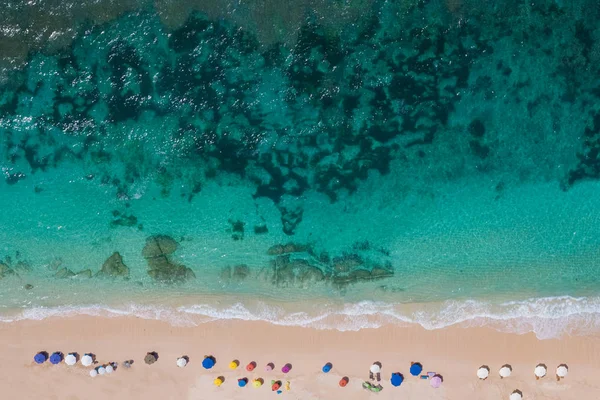 Aerial view to ocean waves. Top view of beautiful beach. Aerial drone shot of ocean water at the beach