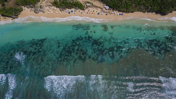 Aerial view to ocean waves. Top view of beautiful beach. Aerial drone shot of ocean water at the beach