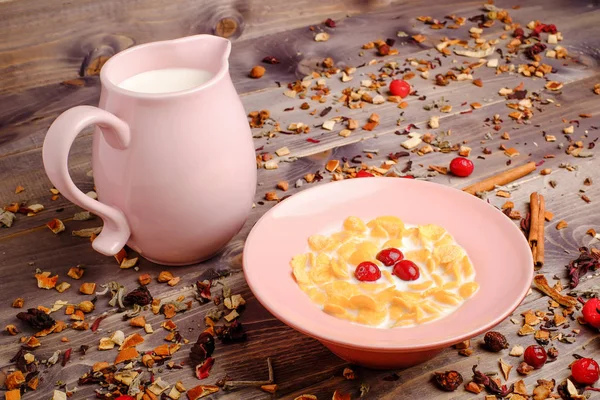 corn cereals in the pink plate with milk