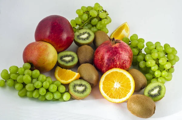 Tropical fruits on a white background, juicy still-life from fruit. Useful fruit for a healthy diet. Mix of different fruits.