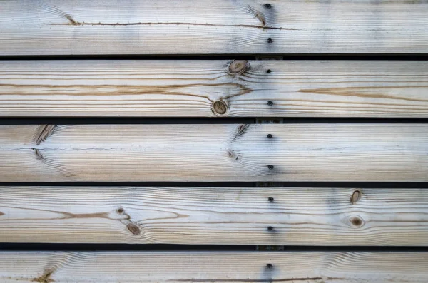 Wooden background of the boards. Horizontal boards color bleached oak. Horizontal fence strips with iron nails.