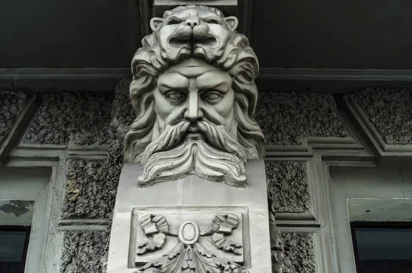 Male bas-relief on the facade. Man\'s head, stucco for the background