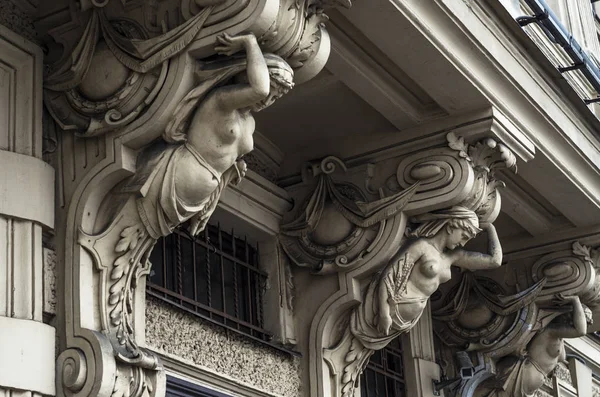 fragment of female sculpture of a city building