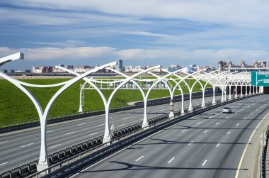 High-speed toll road, the central section of the western high-speed section. Autobahn, high-speed highway. Auto highway bypassing the city center. Russia, St. Petersburg, May 28, 2018 clipart