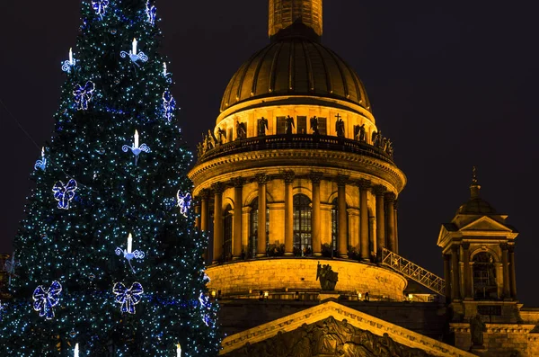 Night city in the light of lights. Christmas tree closeup in front of St. Isaac\'s Cathedral. Background for postcards. St. Petersburg, St. Isaac\'s Square, Russia, December 29, 2017