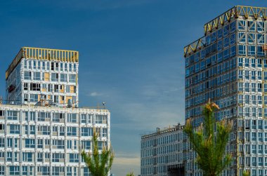 Altın Şehir konut kompleksinin inşaatı devam ediyor. Modern bina cepheleri dekorasyonu. Havalandırmalı menteşeler ve altın dekoratif unsurlar. Rusya, St. Petersburg, 9 Haziran 2020