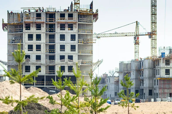 Construction of a residential complex by the sea. The progress of construction of the residential complex Morskaya embankment. Houses in the sand by the water. Russia, St. Petersburg, June 9, 2020