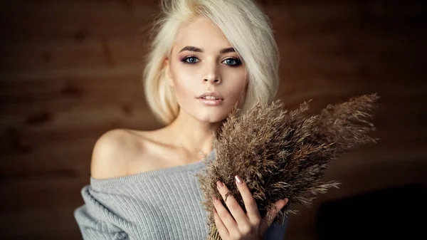 Mooie vrouw met blonde haren en naakt make-up poseren met bou — Stockfoto