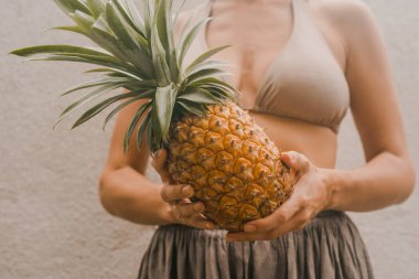 boho giysili kadın tutmak tropikal meyve ananas elinde