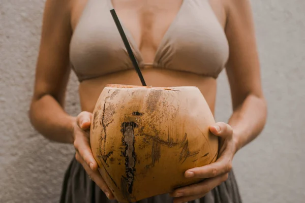 Woman in boho clothes keep the tropical fruit young coconut in h — Stock Photo, Image