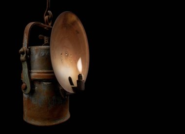 Carbide lamp on black background clipart
