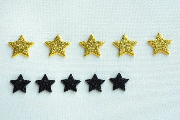 five golden stars and five black stars. concept rating and antirating