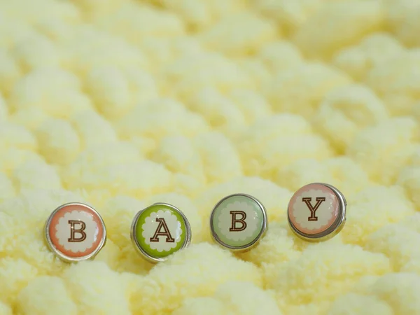 Word Baby Buttons Yellow Plush Knitted Rug Space Copying — Stock Photo, Image