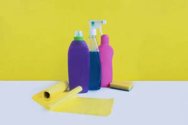 Multicolored Bottles Cleaning Products Trash Bags Yellow White Background Space — Stock Photo, Image