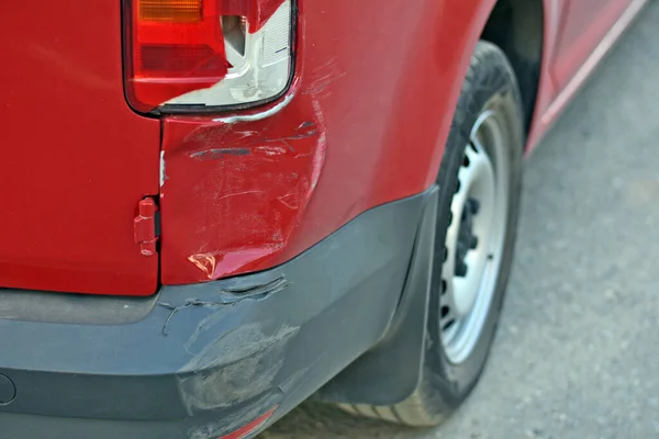 Schade aan de auto na een ongeluk. deuk in de auto en kapotte koplamp. krassen op autoverf. ongeval op de weg. — Stockfoto